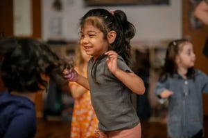 A Seedlings Blue student jumping for joy during music and movement